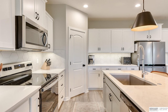 8622 N 177th St, Bennington, NE 68007 - kitchen featuring appliances with stainless steel finishes, a sink, white cabinets, tasteful backsplash, and recessed lighting