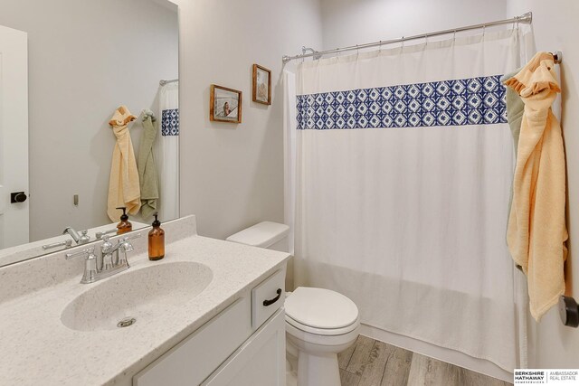 8622 N 177th St, Bennington, NE 68007 - full bath featuring toilet, vanity, wood finished floors, and curtained shower