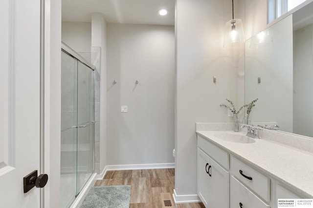 8622 N 177th St, Bennington, NE 68007 - bathroom featuring vanity, a shower stall, wood finished floors, toilet, and baseboards