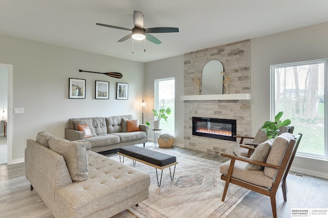 8622 N 177th St, Bennington, NE 68007 - living area with a ceiling fan, a stone fireplace, light wood finished floors, and baseboards