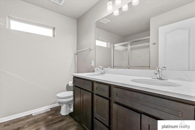 7784 N 88th Ave, Omaha, NE 68122 - full bath with a shower stall, double vanity, and wood finished floors