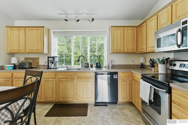 7628 Bondesson St, Omaha, NE 68122 - kitchen with appliances with stainless steel finishes, a sink, light brown cabinetry, and light countertops