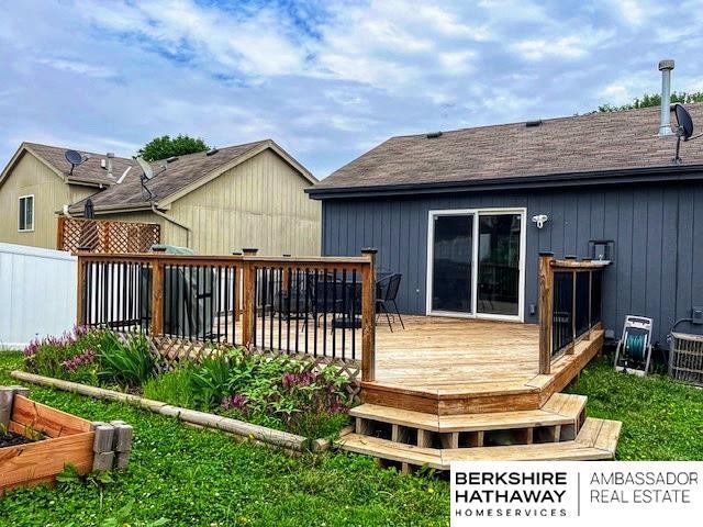 7628 Bondesson St, Omaha, NE 68122 - rear view of property with a wooden deck and roof with shingles