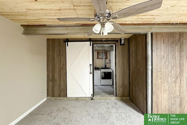 3869 Arbor St, Omaha, NE 68105 - unfurnished bedroom featuring wooden ceiling, carpet floors, independent washer and dryer, a barn door, and baseboards