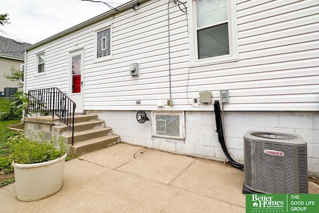 3869 Arbor St, Omaha, NE 68105 - entrance to property featuring central air condition unit and a patio