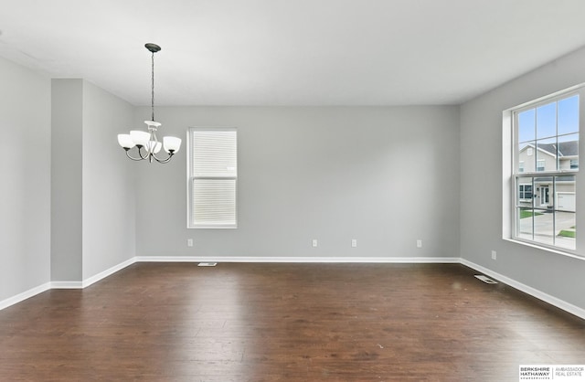 8925 N 159th Ave, Bennington, NE 68007 - spare room with a chandelier, dark wood-style flooring, and baseboards