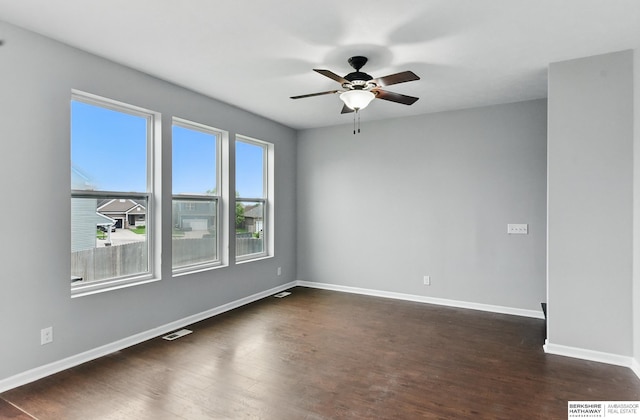 8925 N 159th Ave, Bennington, NE 68007 - empty room featuring dark wood-type flooring, ceiling fan, and baseboards