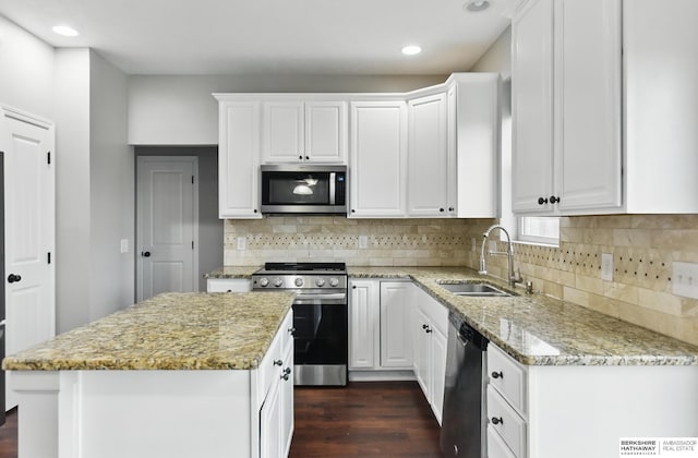 8925 N 159th Ave, Bennington, NE 68007 - kitchen with stainless steel appliances, a sink, white cabinetry, recessed lighting, and light stone counters
