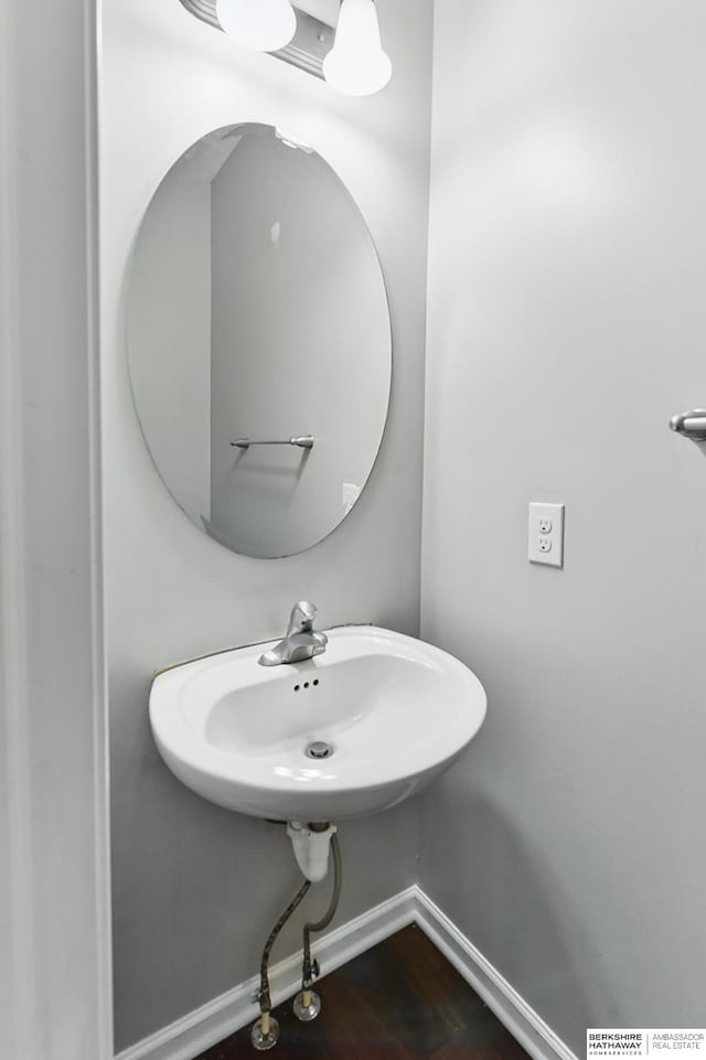 8925 N 159th Ave, Bennington, NE 68007 - bathroom with baseboards, a sink, and wood finished floors