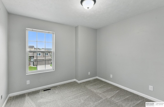 8925 N 159th Ave, Bennington, NE 68007 - carpeted empty room featuring a textured ceiling and baseboards