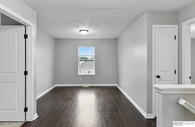 8925 N 159th Ave, Bennington, NE 68007 - spare room featuring baseboards, dark wood finished floors, and a textured ceiling