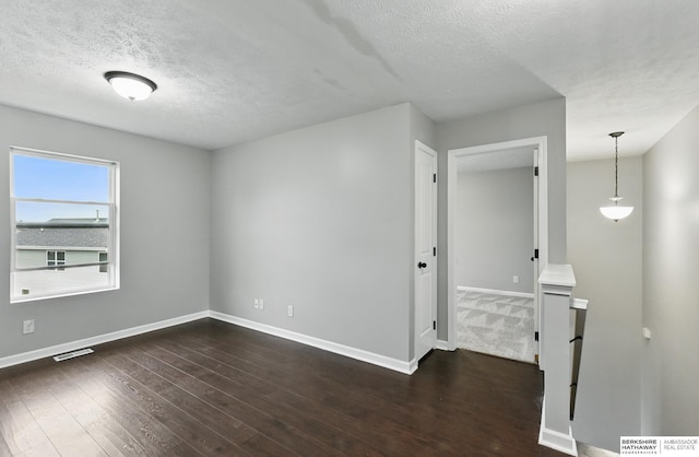 8925 N 159th Ave, Bennington, NE 68007 - empty room featuring a textured ceiling, baseboards, and dark wood-style floors