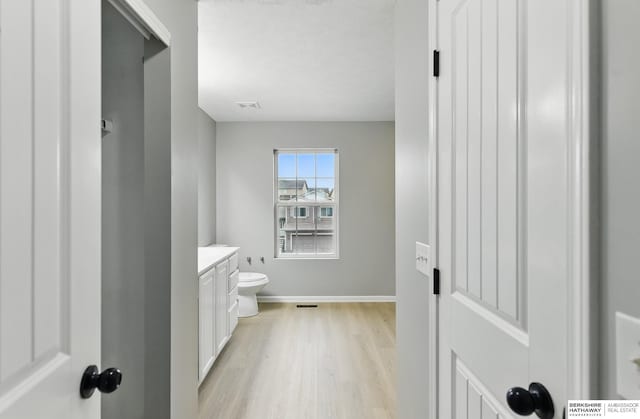 8925 N 159th Ave, Bennington, NE 68007 - bathroom with wood finished floors, baseboards, vanity, and toilet