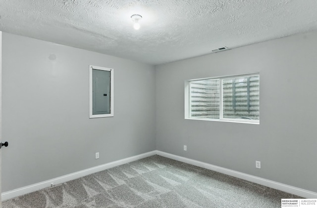 8925 N 159th Ave, Bennington, NE 68007 - spare room featuring electric panel, a textured ceiling, carpet floors, and baseboards