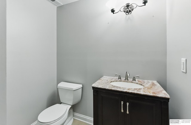 8925 N 159th Ave, Bennington, NE 68007 - bathroom with toilet, vanity, and baseboards