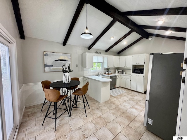 15461 Harney St, Omaha, NE 68154 - kitchen with stainless steel appliances, white cabinets, light countertops, a sink, and hanging light fixtures
