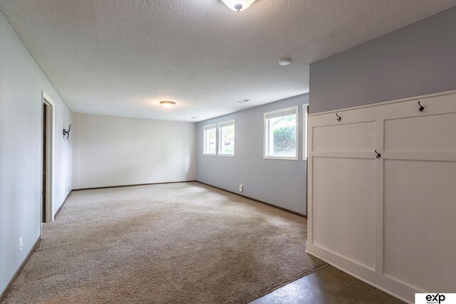 15461 Harney St, Omaha, NE 68154 - carpeted spare room with a textured ceiling, a smoke detector, and baseboards