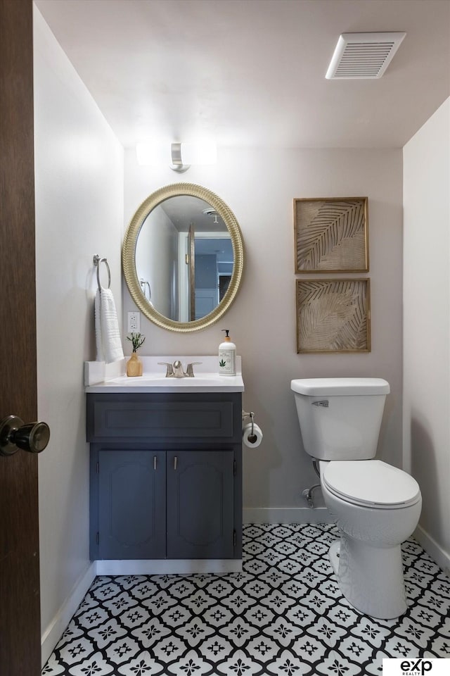 15461 Harney St, Omaha, NE 68154 - bathroom with baseboards, toilet, vanity, and tile patterned floors