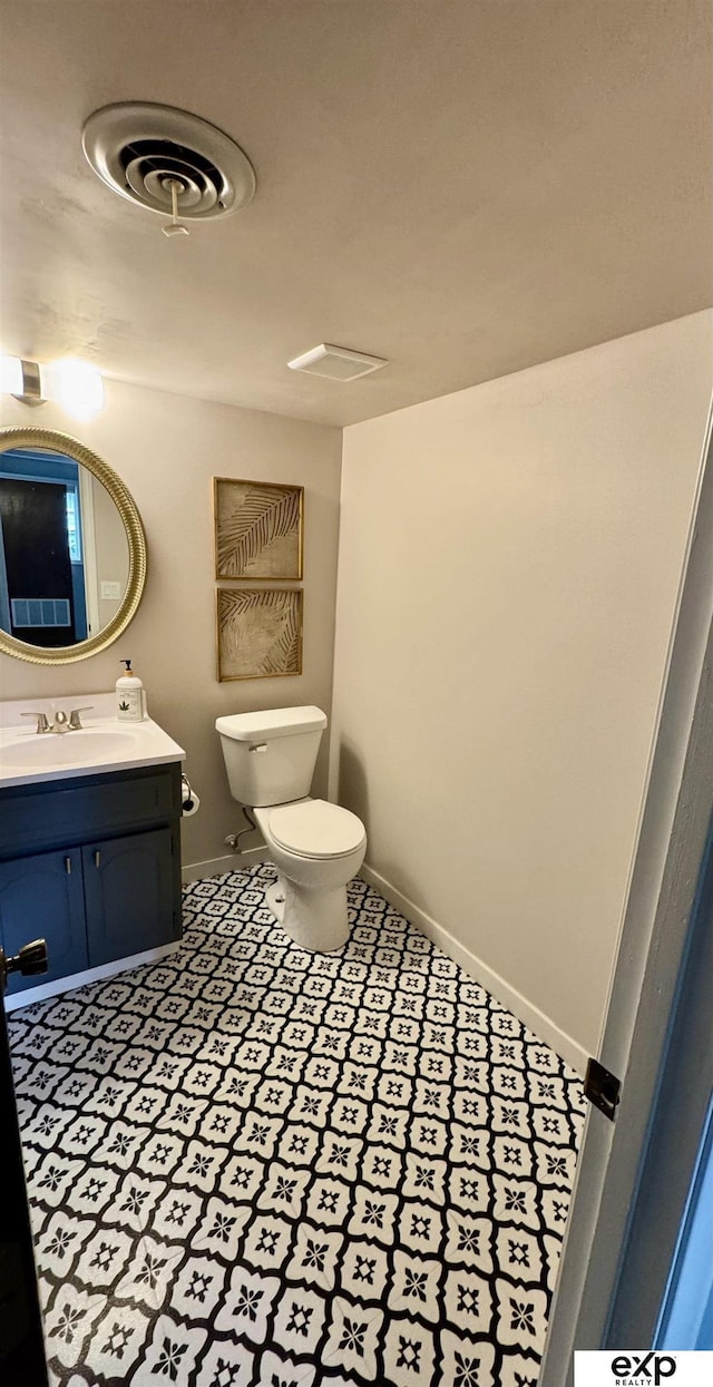 15461 Harney St, Omaha, NE 68154 - bathroom with toilet, vanity, and baseboards