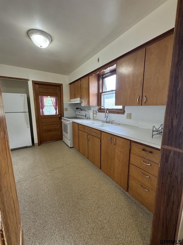 1725 S 23rd St, Lincoln, NE 68502 - kitchen with white appliances, a sink, light countertops, and brown cabinetry