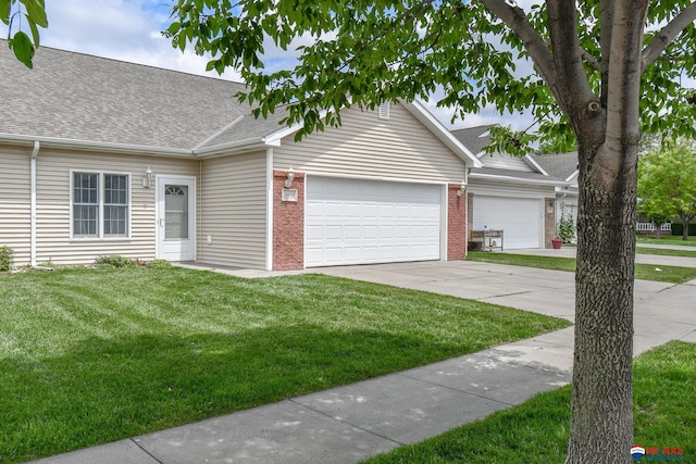 3934 Ballard Ct, Lincoln, NE 68504 - view of front of property featuring a garage, concrete driveway, roof with shingles, a front yard, and brick siding