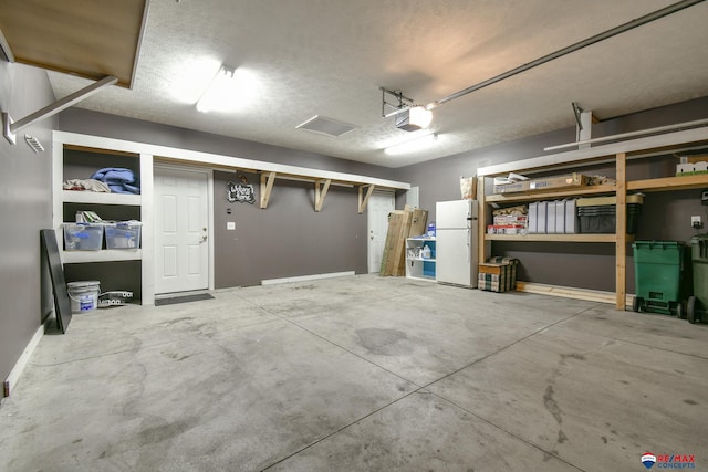 3934 Ballard Ct, Lincoln, NE 68504 - garage with freestanding refrigerator and a garage door opener
