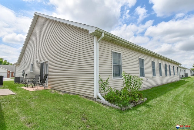 3934 Ballard Ct, Lincoln, NE 68504 - view of side of property with a patio, a yard, and central air condition unit