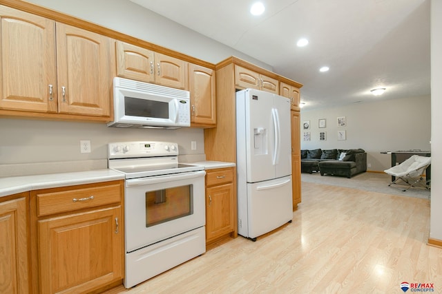 3934 Ballard Ct, Lincoln, NE 68504 - kitchen featuring white appliances, open floor plan, light wood finished floors, light countertops, and recessed lighting