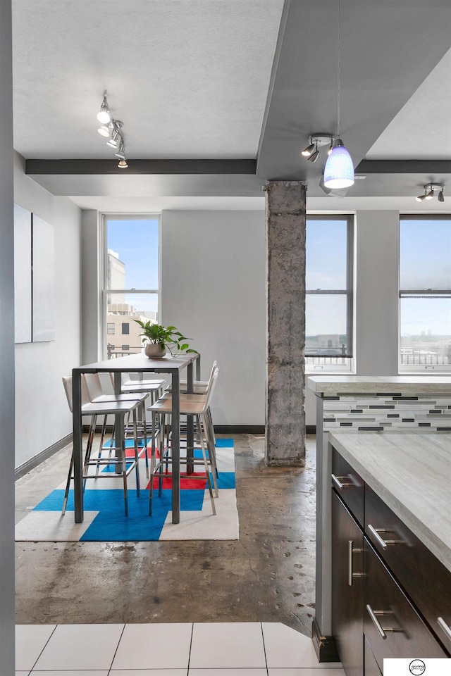 100 N 12th St Unit 904, Lincoln, NE 68508 - dining room with baseboards and concrete flooring