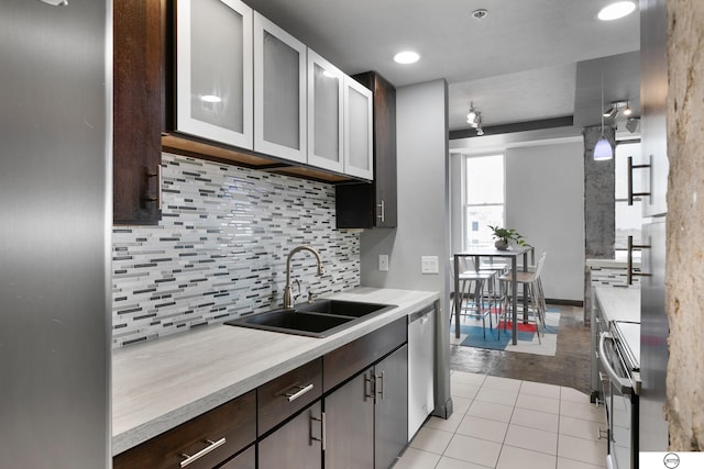 100 N 12th St Unit 904, Lincoln, NE 68508 - kitchen with a sink, dark brown cabinets, light countertops, backsplash, and recessed lighting