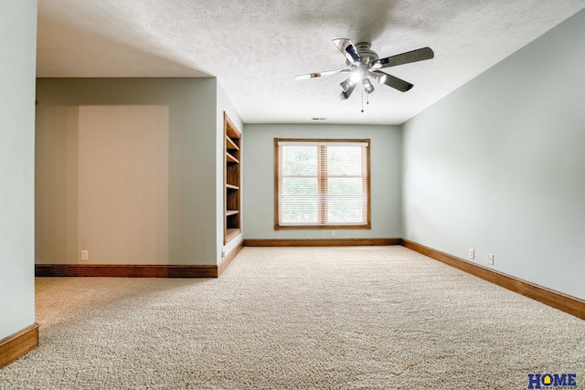 8240 Dorset Dr, Lincoln, NE 68510 - carpeted empty room featuring baseboards, a textured ceiling, ceiling fan, and built in shelves