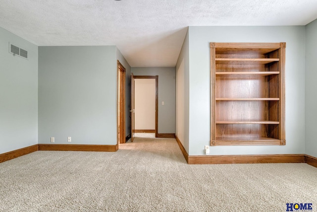 8240 Dorset Dr, Lincoln, NE 68510 - carpeted empty room with baseboards and a textured ceiling