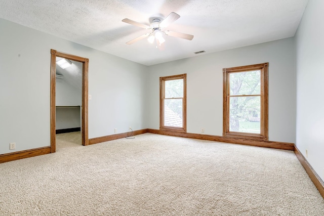 8240 Dorset Dr, Lincoln, NE 68510 - carpeted empty room featuring plenty of natural light, ceiling fan, baseboards, and a textured ceiling