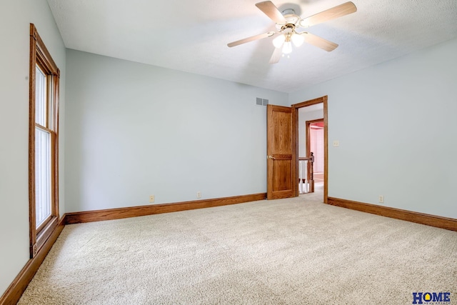8240 Dorset Dr, Lincoln, NE 68510 - unfurnished room with light carpet, baseboards, and a ceiling fan