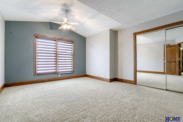 8240 Dorset Dr, Lincoln, NE 68510 - unfurnished bedroom featuring carpet flooring, a closet, baseboards, vaulted ceiling, and a ceiling fan
