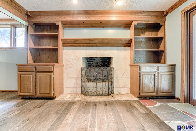 8240 Dorset Dr, Lincoln, NE 68510 - unfurnished living room with wood finished floors, crown molding, baseboards, and a textured ceiling