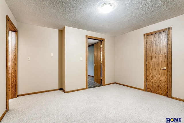 8240 Dorset Dr, Lincoln, NE 68510 - empty room with carpet, a textured ceiling, and baseboards