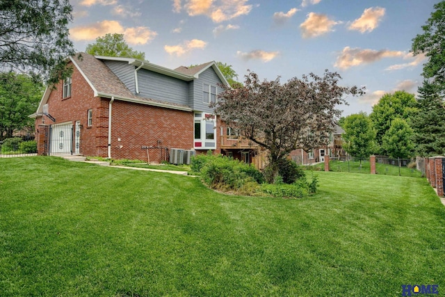 8240 Dorset Dr, Lincoln, NE 68510 - view of home's exterior featuring brick siding, roof with shingles, central air condition unit, and an attached garage