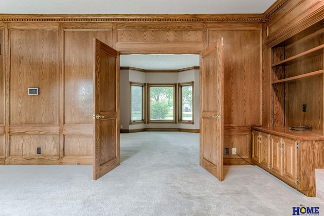 8240 Dorset Dr, Lincoln, NE 68510 - hallway with crown molding, light colored carpet, wooden walls, and baseboards