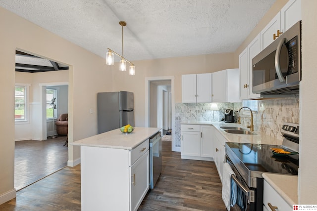 1512 N 41st Ave, Omaha, NE 68111 - kitchen featuring stainless steel appliances, a sink, dark wood-style flooring, tasteful backsplash, and a textured ceiling