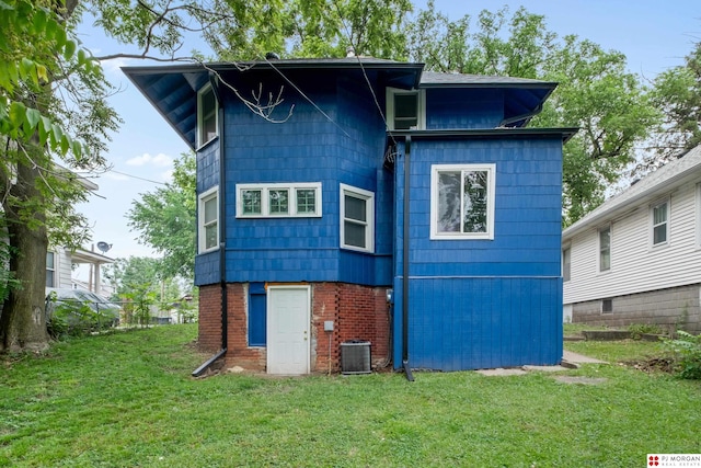 1512 N 41st Ave, Omaha, NE 68111 - rear view of house with a lawn, central air condition unit, and brick siding
