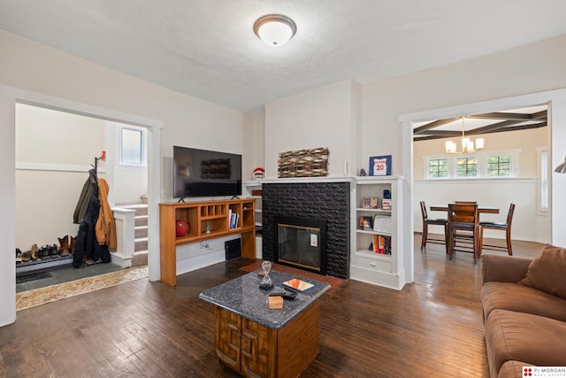 1512 N 41st Ave, Omaha, NE 68111 - living room with a chandelier, a glass covered fireplace, and dark wood-type flooring