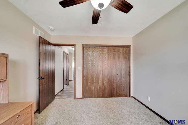 1309 Ridge Rd, Hickman, NE 68372 - unfurnished bedroom featuring light carpet, a closet, and ceiling fan