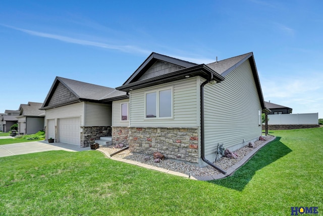 1309 Ridge Rd, Hickman, NE 68372 - view of front of home featuring driveway, a front yard, an attached garage, and stone siding
