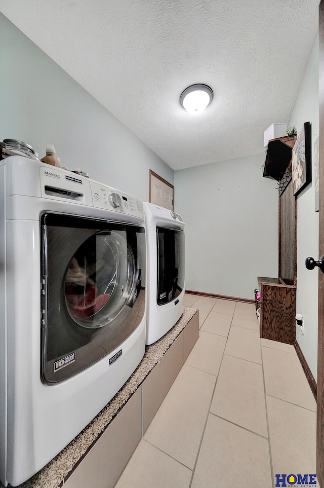1309 Ridge Rd, Hickman, NE 68372 - washroom with independent washer and dryer, light tile patterned floors, and a textured ceiling