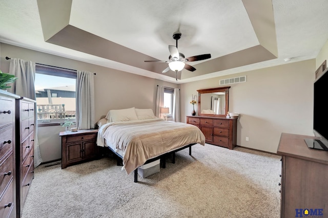 1309 Ridge Rd, Hickman, NE 68372 - bedroom with a tray ceiling, light carpet, and ceiling fan