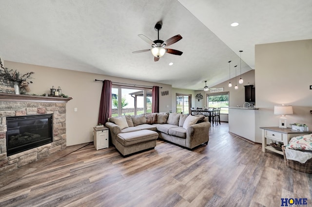 1309 Ridge Rd, Hickman, NE 68372 - living room featuring a ceiling fan, wood finished floors, vaulted ceiling, a fireplace, and recessed lighting