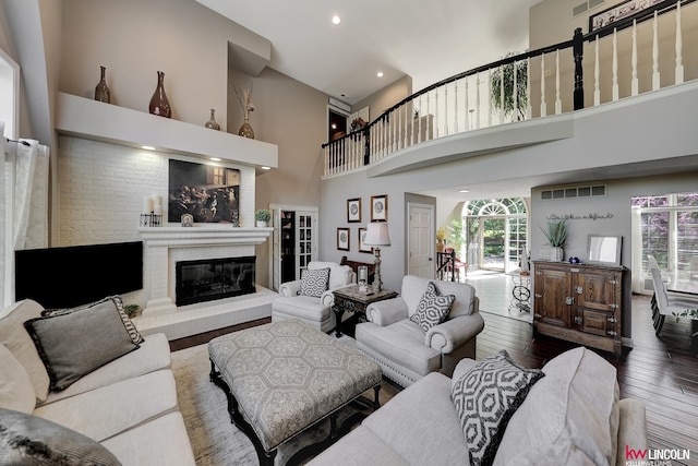 5100 Bridle Ln, Lincoln, NE 68516 - living area with wood-type flooring, a high ceiling, a glass covered fireplace, and recessed lighting