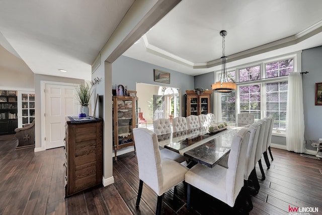 5100 Bridle Ln, Lincoln, NE 68516 - dining space with dark wood-style flooring, a tray ceiling, and baseboards