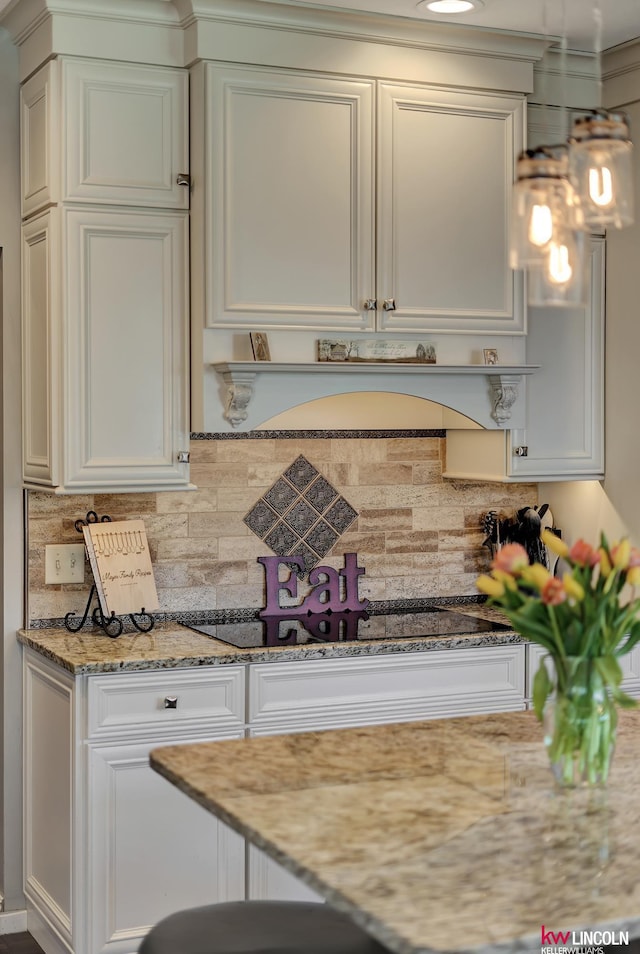 5100 Bridle Ln, Lincoln, NE 68516 - kitchen featuring decorative backsplash, light stone counters, and white cabinetry